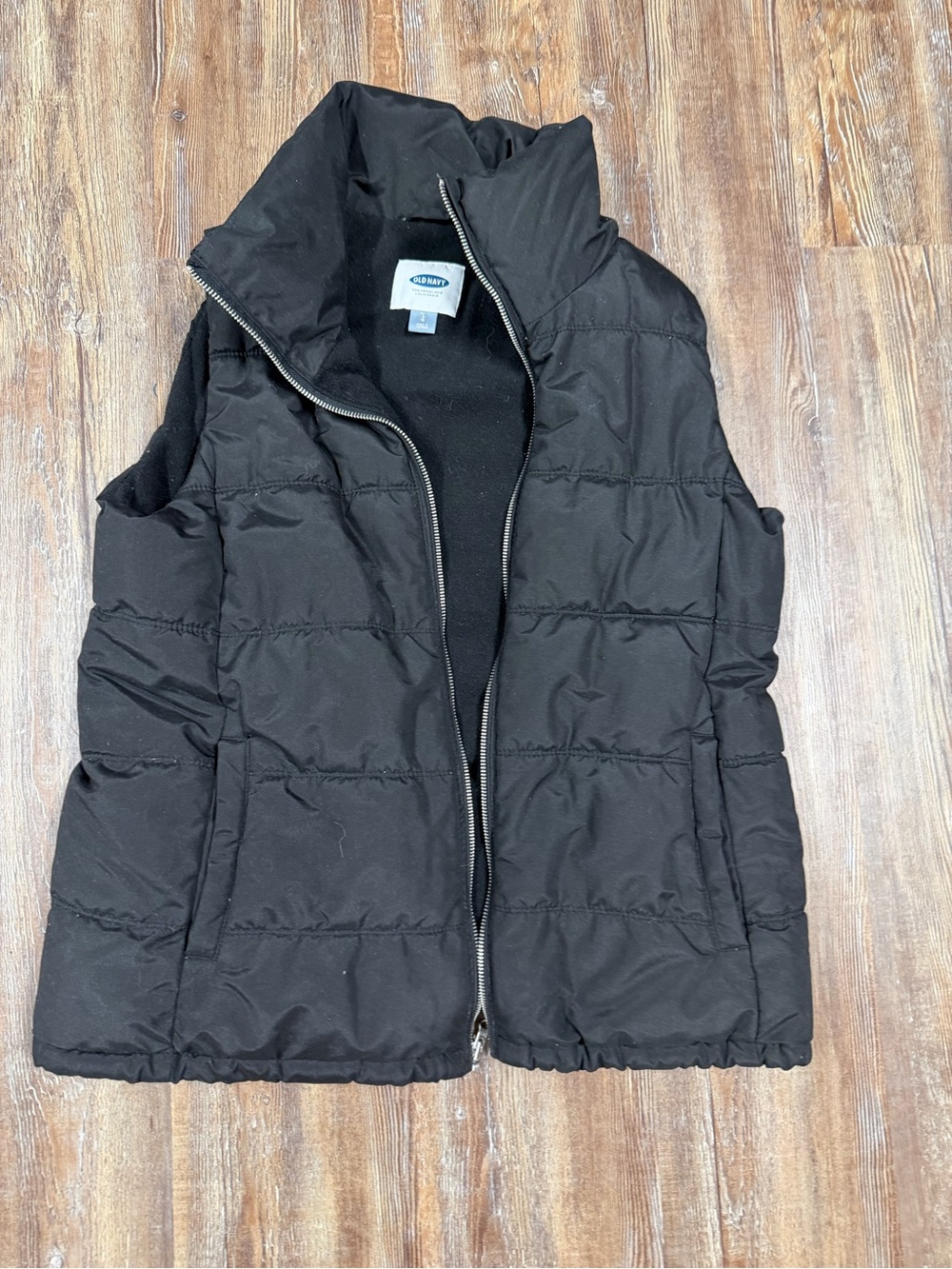 Old Navy black puffer vest with horizontal quilting, size L